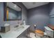 Bathroom with a marble vanity and wood-accented toilet at 11222 Conifer Mountain Rd, Conifer, CO 80433