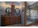 Modern bathroom with double sinks, granite countertops, and a glass-enclosed shower with bench at 11222 Conifer Mountain Rd, Conifer, CO 80433