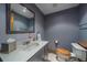 Nicely appointed bathroom featuring sink, toilet, and mirror with modern fixtures at 11222 Conifer Mountain Rd, Conifer, CO 80433