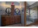 Stylish bathroom featuring double sinks, granite countertops, a custom cabinet and a tiled glass enclosed shower at 11222 Conifer Mountain Rd, Conifer, CO 80433