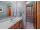 Cozy bathroom featuring a single sink vanity, tiled countertop, and shower with curtain at 11222 Conifer Mountain Rd, Conifer, CO 80433