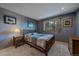 Comfortable bedroom featuring neutral walls, soft carpet, and a large window with wooded view at 11222 Conifer Mountain Rd, Conifer, CO 80433