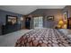 Bright bedroom featuring vaulted ceilings, neutral carpet, a large window and a doorway to a patio at 11222 Conifer Mountain Rd, Conifer, CO 80433