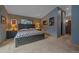 Bedroom with carpet, neutral walls, a large window and a doorway leading to an en suite bathroom at 11222 Conifer Mountain Rd, Conifer, CO 80433