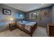 Bedroom featuring natural light, wood accents, and neutral gray walls at 11222 Conifer Mountain Rd, Conifer, CO 80433