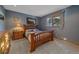 Cozy bedroom features a wooden bed frame, soft carpet, and a bright window offering natural light at 11222 Conifer Mountain Rd, Conifer, CO 80433