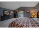 Bedroom featuring a queen bed, dresser, sliding doors, and natural light at 11222 Conifer Mountain Rd, Conifer, CO 80433