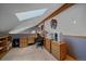 Attic Bonus Room featuring a skylight, wood cabinets and desk, offering a flexible space at 11222 Conifer Mountain Rd, Conifer, CO 80433