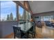 Dining room with vaulted ceilings, hardwood floors, and large windows offering panoramic wooded views at 11222 Conifer Mountain Rd, Conifer, CO 80433