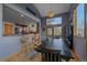 Open concept dining room featuring light wood floors and a bar with seating at 11222 Conifer Mountain Rd, Conifer, CO 80433