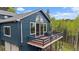 Beautiful two-story home with a deck, and a large window at 11222 Conifer Mountain Rd, Conifer, CO 80433