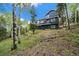 Two-story home on a wooded lot with multiple decks at 11222 Conifer Mountain Rd, Conifer, CO 80433
