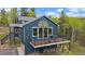 Charming two-story home with multiple decks and surrounding trees at 11222 Conifer Mountain Rd, Conifer, CO 80433
