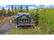 A mountain home featuring a well-maintained deck, nestled in a heavily treed, private lot at 11222 Conifer Mountain Rd, Conifer, CO 80433