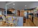 Kitchen featuring a breakfast bar with seating, stainless steel appliances, and hardwood floors at 11222 Conifer Mountain Rd, Conifer, CO 80433