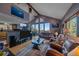 Open living room boasts vaulted ceilings, stone fireplace and stunning views from many windows at 11222 Conifer Mountain Rd, Conifer, CO 80433