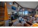 Living room featuring high ceilings, a shark painting, and hardwood flooring at 11222 Conifer Mountain Rd, Conifer, CO 80433