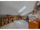Home office features carpet, skylight, and built-in shelving for a functional workspace at 11222 Conifer Mountain Rd, Conifer, CO 80433