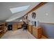 Office space illuminated with a skylight, featuring neutral carpet, wood accents, and a functional desk area at 11222 Conifer Mountain Rd, Conifer, CO 80433