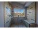 Stunning shower with bench seating and a window to outdoor scenery at 11222 Conifer Mountain Rd, Conifer, CO 80433