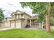 Charming two-story home featuring a well-manicured lawn and a welcoming front porch at 5185 E Weaver Dr, Centennial, CO 80121