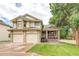 Charming two-story home with a well-manicured lawn, two-car garage and inviting front porch at 5185 E Weaver Dr, Centennial, CO 80121