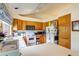 Functional kitchen with white appliances, wood cabinets, and a bright window view at 5185 E Weaver Dr, Centennial, CO 80121