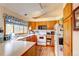 Functional kitchen with white appliances, wood cabinets, and a bright window view at 5185 E Weaver Dr, Centennial, CO 80121