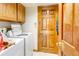 Functional laundry area with washer and dryer, cabinet storage, and convenient access; awaiting personalization at 5185 E Weaver Dr, Centennial, CO 80121