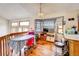 Open living area featuring hardwood floors, a bar, and bright natural light at 5185 E Weaver Dr, Centennial, CO 80121