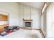 Bright living room features a brick fireplace and tiled floors, creating a cozy and inviting atmosphere at 5185 E Weaver Dr, Centennial, CO 80121