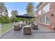 Spacious outdoor deck with patio furniture, umbrella, and view of landscaped backyard at 5428 Golden Currant Way, Parker, CO 80134