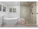 Luxurious bathroom featuring a soaking tub, glass shower, and herringbone tile flooring at 5428 Golden Currant Way, Parker, CO 80134