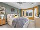 Stylish bedroom with neutral tones, bright window, ceiling fan, and decorative accents at 5428 Golden Currant Way, Parker, CO 80134