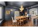 Elegant dining room boasts a chandelier, dark walls, and access to the kitchen at 5428 Golden Currant Way, Parker, CO 80134
