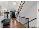 Open and airy foyer with grand staircase, chandelier and beautiful hardwood floors at 5428 Golden Currant Way, Parker, CO 80134
