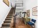 An elegant foyer featuring a staircase, hardwood floors, and views into the living space at 5428 Golden Currant Way, Parker, CO 80134