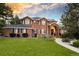 Charming two-story brick home with a lush lawn, manicured landscaping, and inviting walkway at 5428 Golden Currant Way, Parker, CO 80134