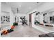 Well-equipped home gym with workout equipment, mirrors, and a motivational setup at 5428 Golden Currant Way, Parker, CO 80134