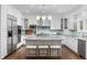 Modern kitchen features stainless steel appliances, granite counters and eat in island at 5428 Golden Currant Way, Parker, CO 80134