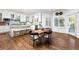 Eat-in kitchen features an island with seating, stainless appliances, and hardwood flooring at 5428 Golden Currant Way, Parker, CO 80134
