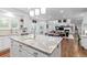Eat-in kitchen with center island flows into the living room with great natural light at 5428 Golden Currant Way, Parker, CO 80134