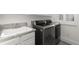 Laundry room featuring a sink, granite counters, modern washer and dryer at 5428 Golden Currant Way, Parker, CO 80134