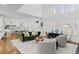 Bright living room features a modern green couch, white chairs and large windows at 5428 Golden Currant Way, Parker, CO 80134