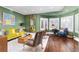 Stylish living room with hardwood floors, comfortable seating, bay windows and elegant decor at 5428 Golden Currant Way, Parker, CO 80134