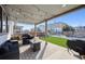 Relaxing covered patio with string lights and outdoor seating, overlooking a well-maintained yard at 18012 E 107Th Ave, Commerce City, CO 80022