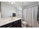 Clean bathroom featuring a single vanity, shower with curtain, and bright lighting at 18012 E 107Th Ave, Commerce City, CO 80022