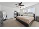 Inviting bedroom with a ceiling fan, neutral walls, and a large window for natural light at 18012 E 107Th Ave, Commerce City, CO 80022