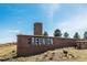 Welcome to Reunion brick sign with community water tower in background and blue skies at 18012 E 107Th Ave, Commerce City, CO 80022