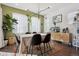 Elegant dining room with table and chairs in a sunlit area, and modern accents at 18012 E 107Th Ave, Commerce City, CO 80022